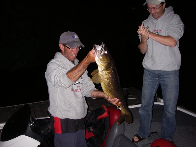 Walleye July 2011.JPG - Joe Finally figured out where the walleye are in his lake..... Trolling out in the main part of the lake over 100 ft of water using deep diving (20’) Rapala Tail Dancers.Last week he landed 2 over 10lbs and lost 3 more, one of which even bigger...This one was 10.7 lbs.All fish he hooked/caught was between 8:30 – 9:00 pm...All were released to fight another day.